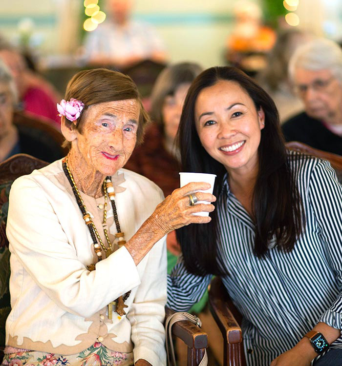 Photo of a female resident and friend at luncheon event