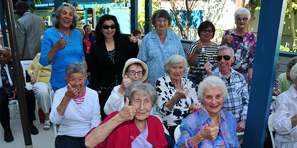 group of elderly giving a thumbs up